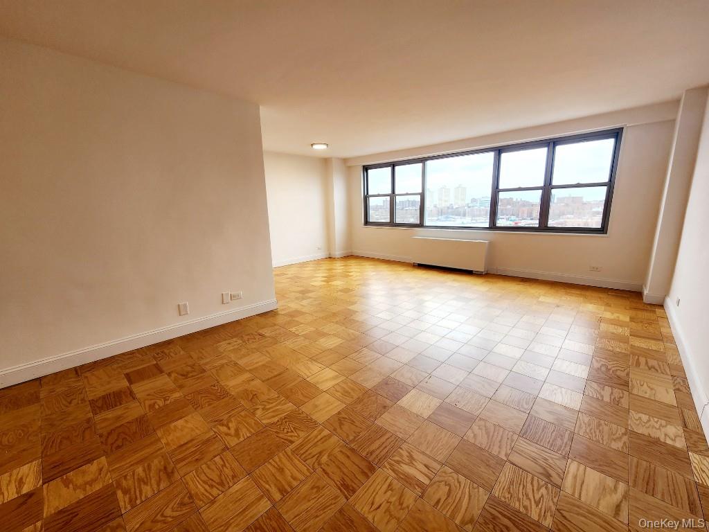 61-20 Grand Central Parkway, Unit A1406 Queens, NY 11375 - Photo 3 of 23 a view of an empty room with a window
