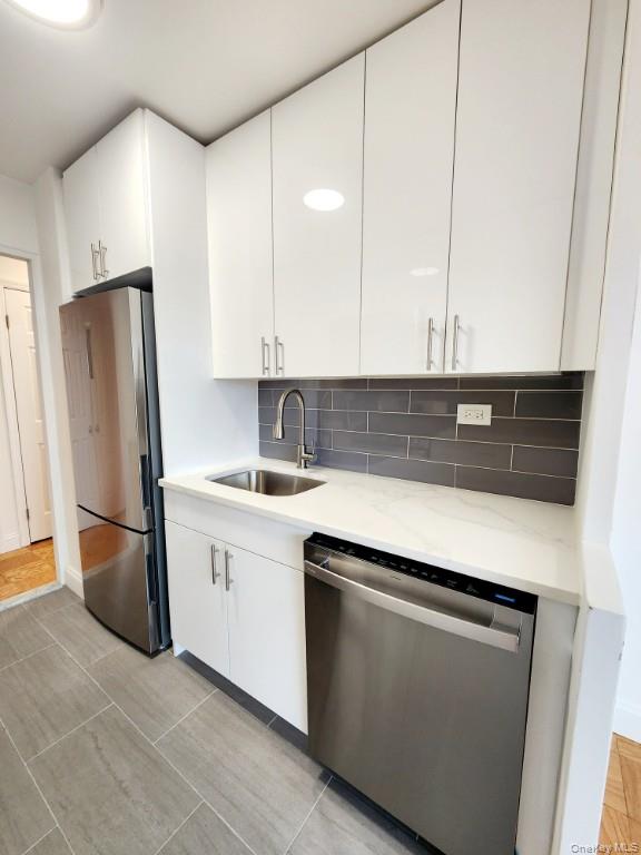 61-20 Grand Central Parkway, Unit A1406 Queens, NY 11375 - Photo 10 of 23 a kitchen with stainless steel appliances a refrigerator sink and cabinets