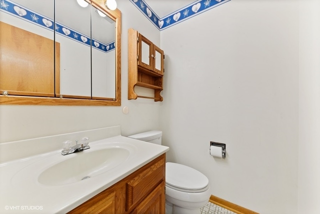560 North Rohlwing Road Palatine, IL 60074 - Photo 11 of 25 a bathroom with a sink and a toilet