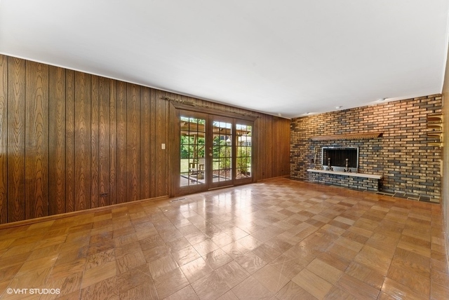 560 North Rohlwing Road Palatine, IL 60074 - Photo 12 of 25 a view of an empty room with a fireplace and a window
