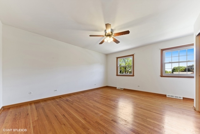 560 North Rohlwing Road Palatine, IL 60074 - Photo 15 of 25 an empty room with wooden floor and windows