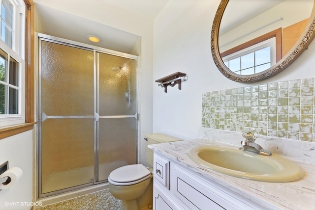 560 North Rohlwing Road Palatine, IL 60074 - Photo 17 of 25 a bathroom with a granite countertop sink and a mirror