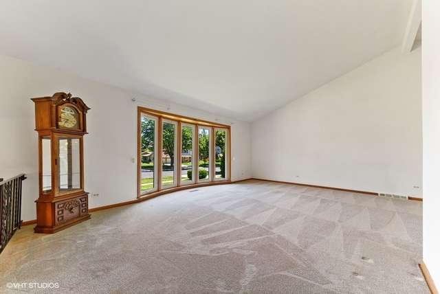 560 North Rohlwing Road Palatine, IL 60074 - Photo 3 of 25 an empty room with windows
