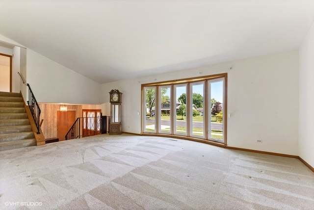 560 North Rohlwing Road Palatine, IL 60074 - Photo 4 of 25 a view of an empty room with glass door and balcony