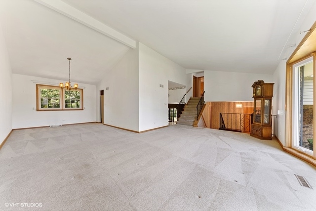 560 North Rohlwing Road Palatine, IL 60074 - Photo 6 of 25 a view of a livingroom with a staircase