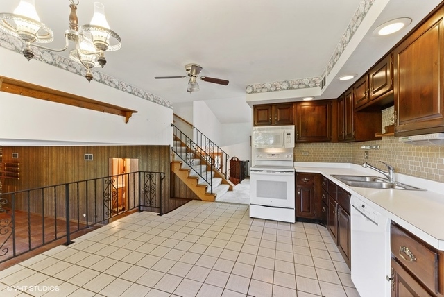 560 North Rohlwing Road Palatine, IL 60074 - Photo 8 of 25 a kitchen with stainless steel appliances granite countertop a sink and cabinets