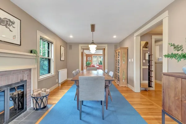 a dining room with furniture window and wooden floor