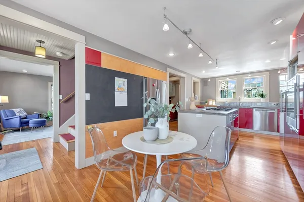 a dining room with furniture and wooden floor