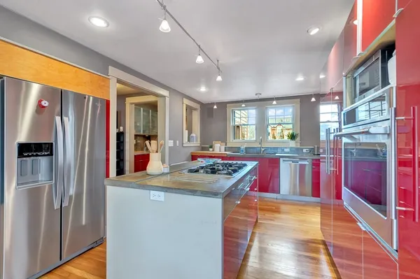 a kitchen with stainless steel appliances granite countertop sink refrigerator and microwave