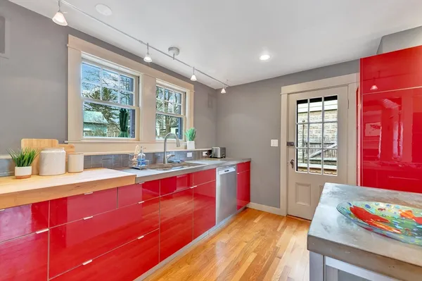 a kitchen with sink and view of living room