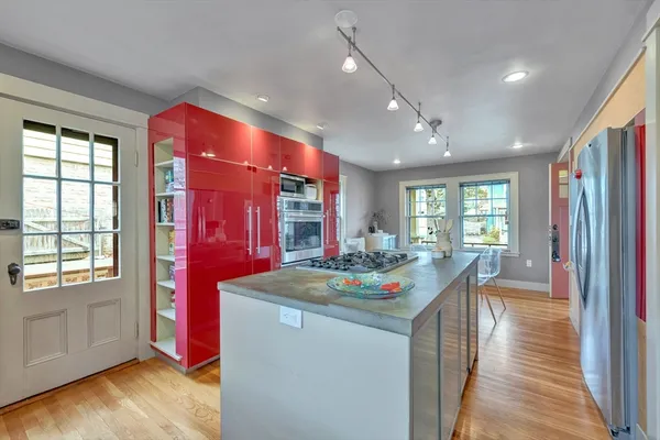 a kitchen with sink refrigerator and window