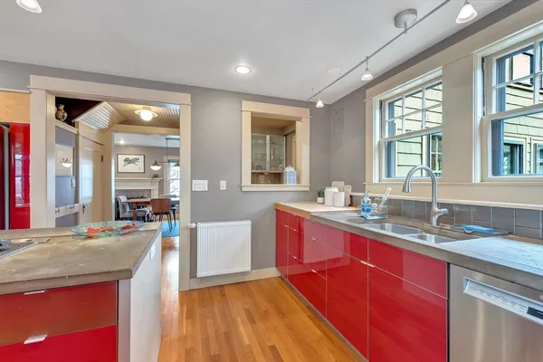 a large kitchen with granite countertop a sink dishwasher stove and cabinets