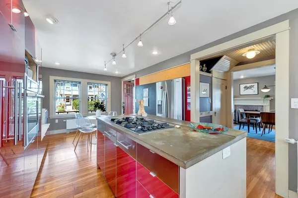 a kitchen with stainless steel appliances granite countertop a stove and cabinets