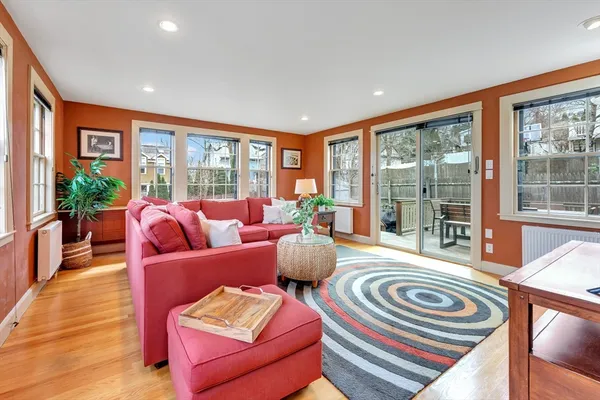 a living room with furniture and floor to ceiling windows