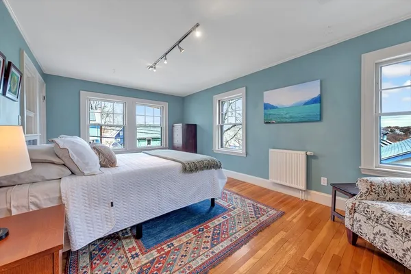 a bedroom with a large bed and a window