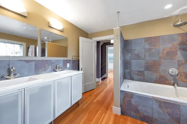 a bathroom with a sink a mirror and a bathtub