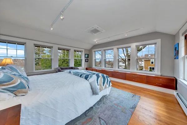 a bed sitting in a room next to a large window