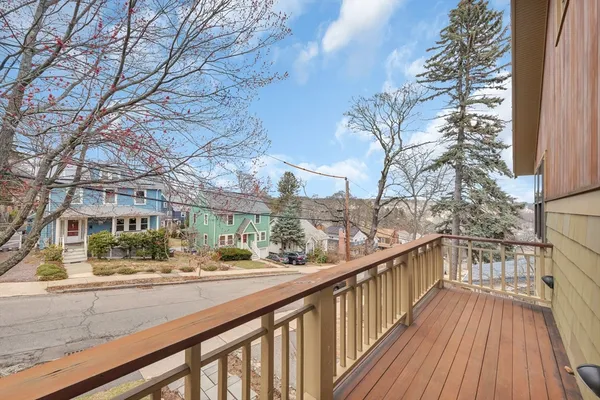 a view of balcony with wooden floor and fence