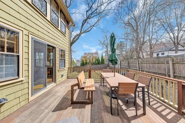 a view of a patio with table and chairs and floor to ceiling window with wooden floor