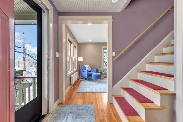 a view of entryway and hall with wooden floor