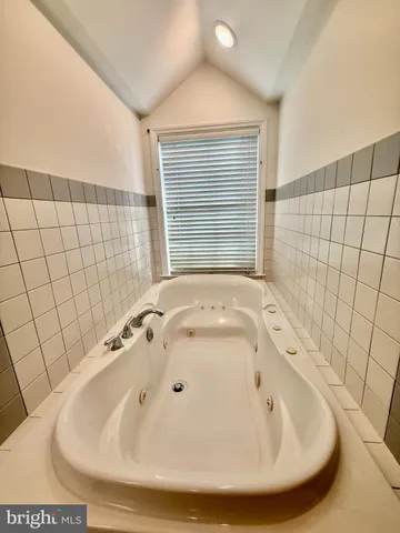 a bathroom with a bathtub and shower