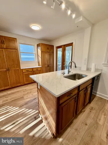 a kitchen with stainless steel appliances granite countertop a sink and dishwasher stove with wooden floor