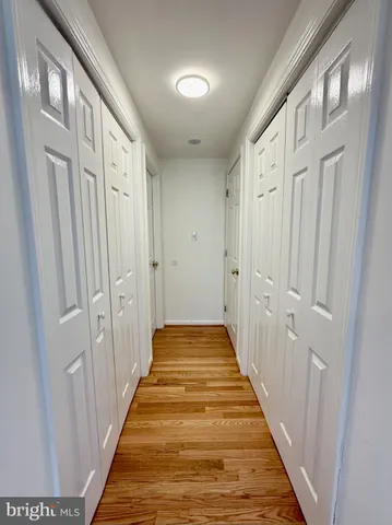a view of a hallway with wooden floor