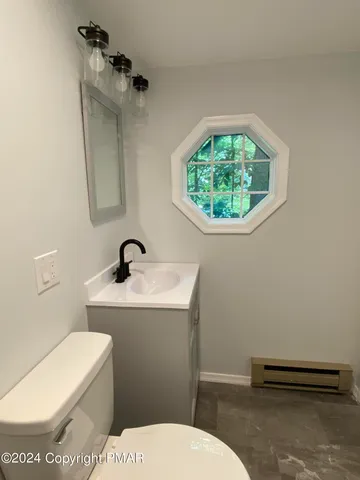 a bathroom with a toilet and a sink