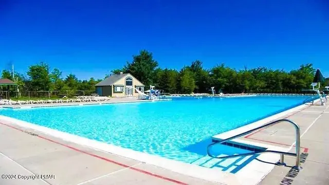 a view of swimming pool with a yard