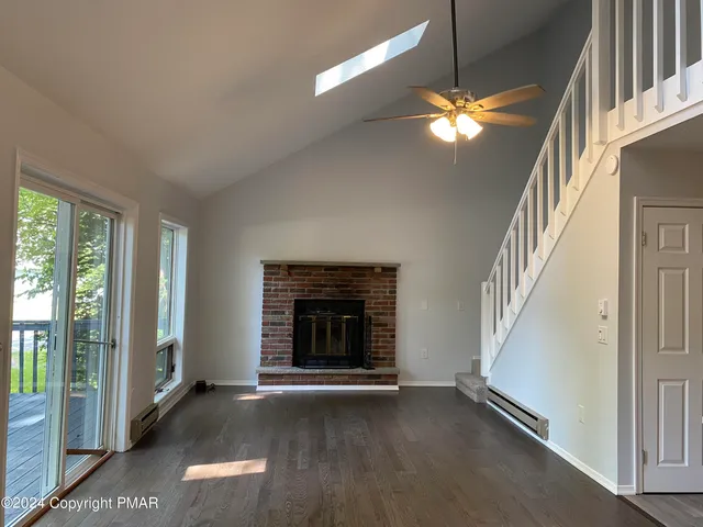 a view of empty room with window and fireplace