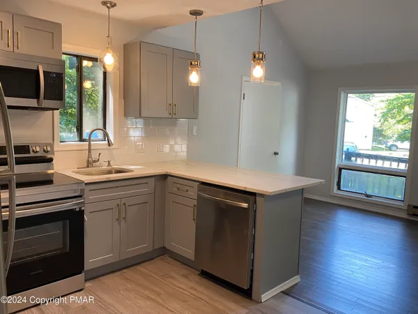 a kitchen with a sink stove and microwave