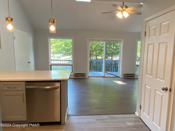 a view of kitchen with granite countertop cabinets and wooden floor