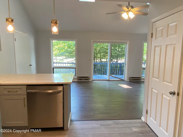 a view of kitchen with granite countertop cabinets and wooden floor