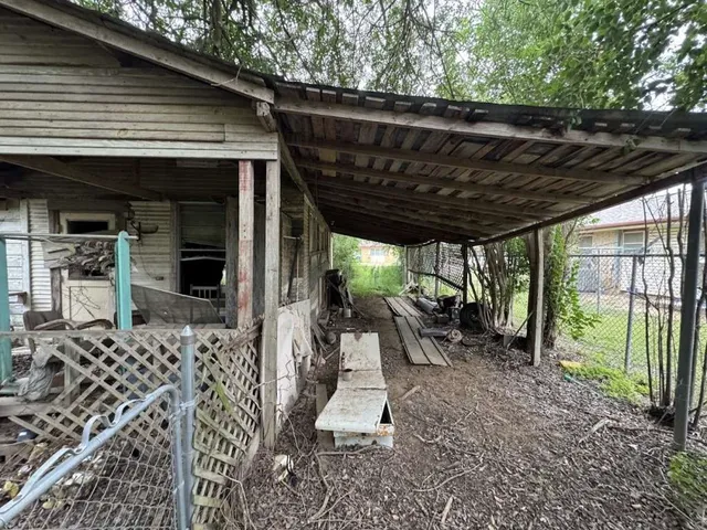 a view of a patio with table and chairs potted plants with large tree