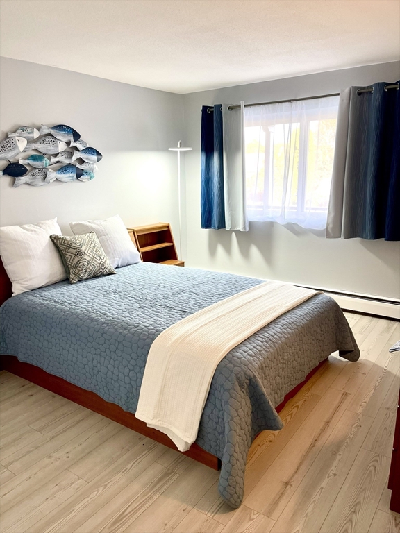 44 Lexington Avenue, Unit 4 Gloucester, MA 01930 - Photo 4 of 11 a bedroom with a large bed and a window