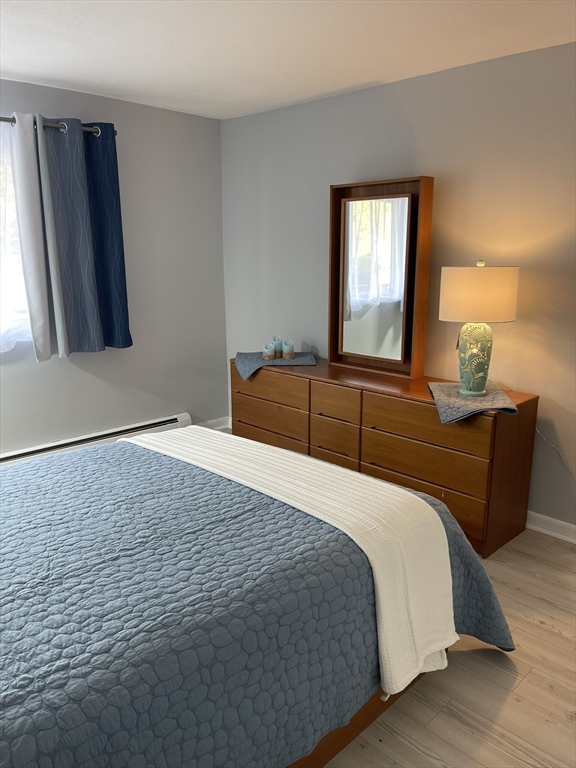 44 Lexington Avenue, Unit 4 Gloucester, MA 01930 - Photo 5 of 11 a bedroom with a bed and window