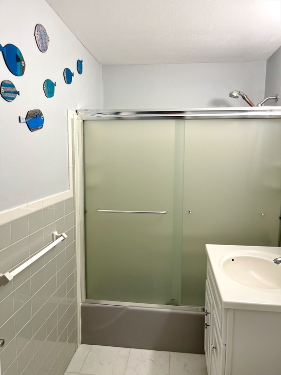 44 Lexington Avenue, Unit 4 Gloucester, MA 01930 - Photo 9 of 11 a bathroom with a window and a shower