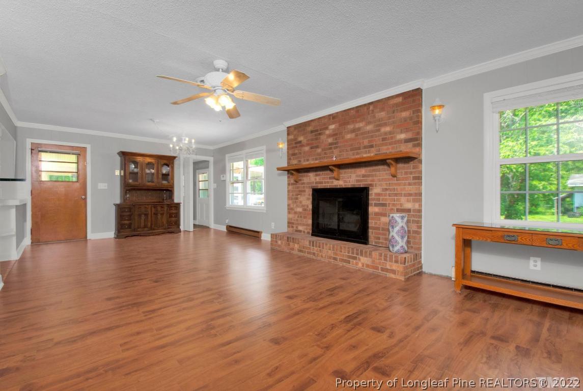 1541 3 Bridge Road Dunn, NC 28334 - Photo 11 of 32 a view of an empty room with wooden floor fireplace and a window