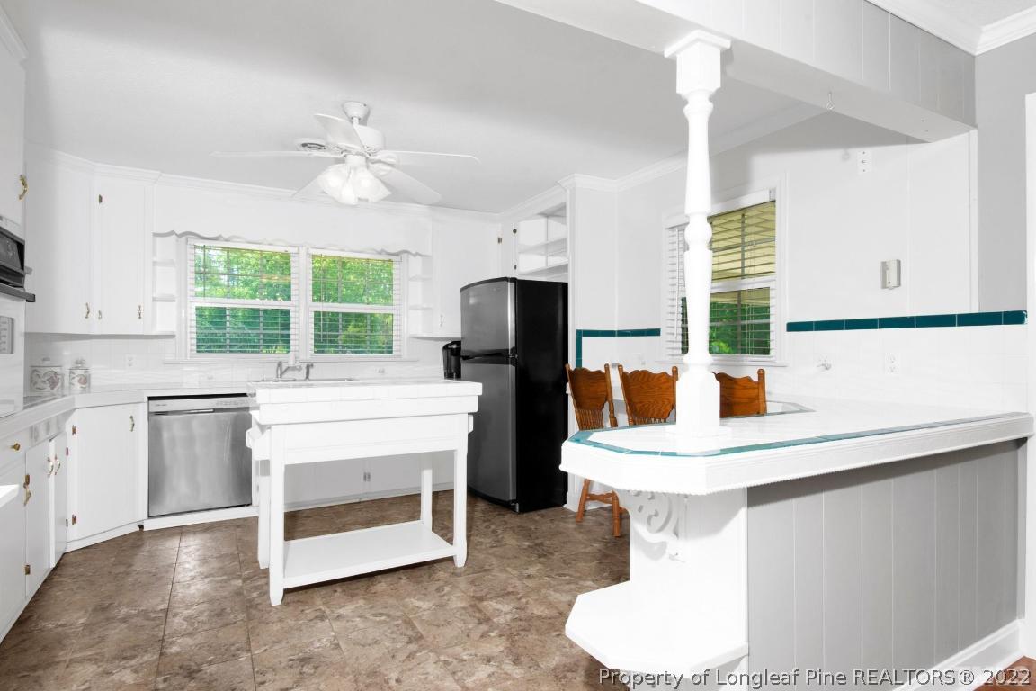 1541 3 Bridge Road Dunn, NC 28334 - Photo 13 of 32 a kitchen with a sink and a stove top oven