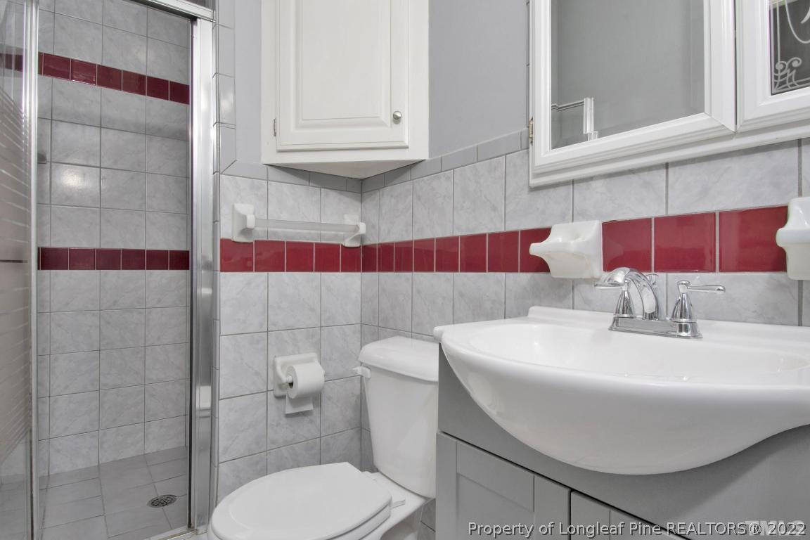 1541 3 Bridge Road Dunn, NC 28334 - Photo 24 of 32 a bathroom with a sink toilet and shower