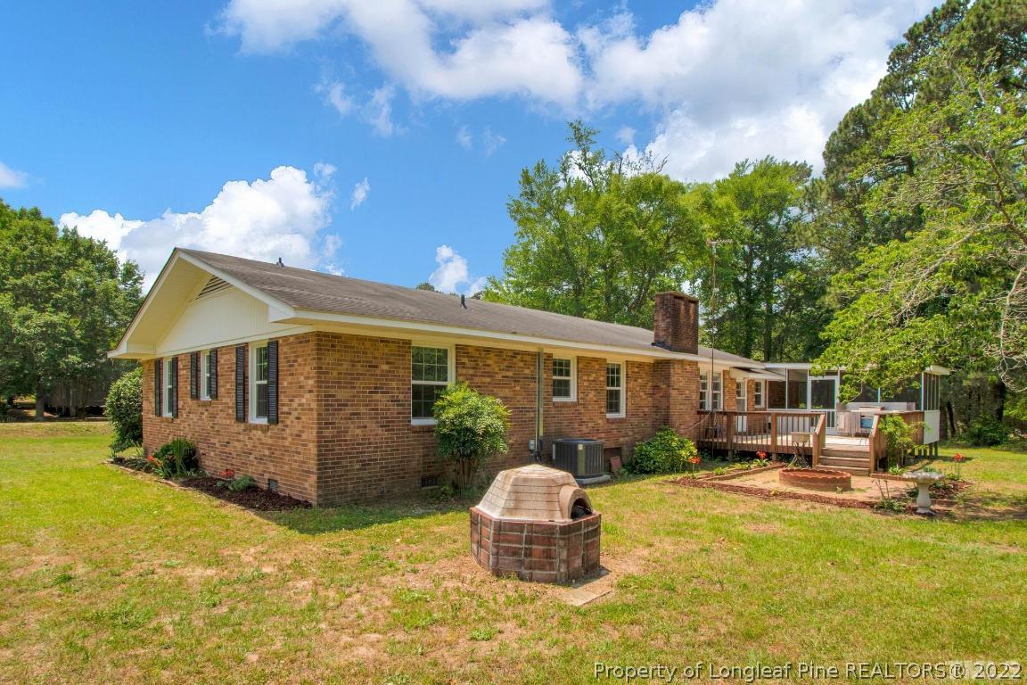 1541 3 Bridge Road Dunn, NC 28334 - Photo 29 of 32 a front view of a house with swimming pool yard and patio