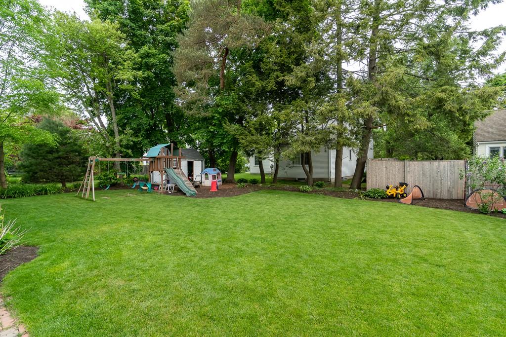 12 Pine Plain Road Wellesley, MA 02481 - Photo 27 of 30 a view of backyard with table and chairs and wooden fence