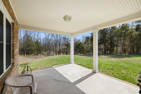 a backyard of a house with table and chairs