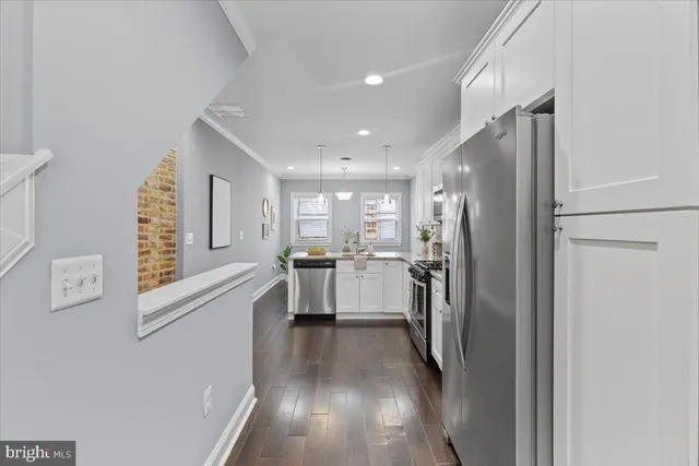 a kitchen with a refrigerator and a sink