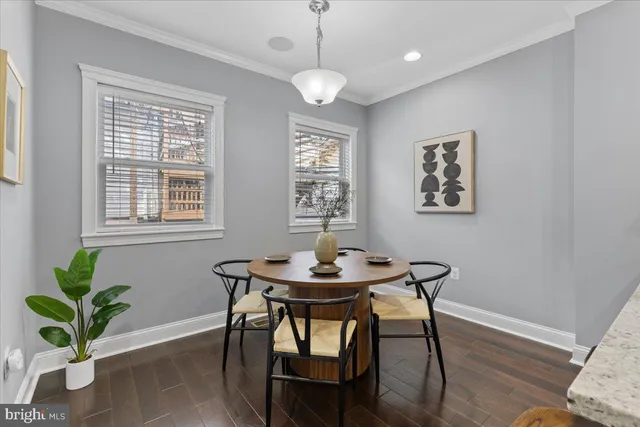 a dining room with furniture and wooden floor