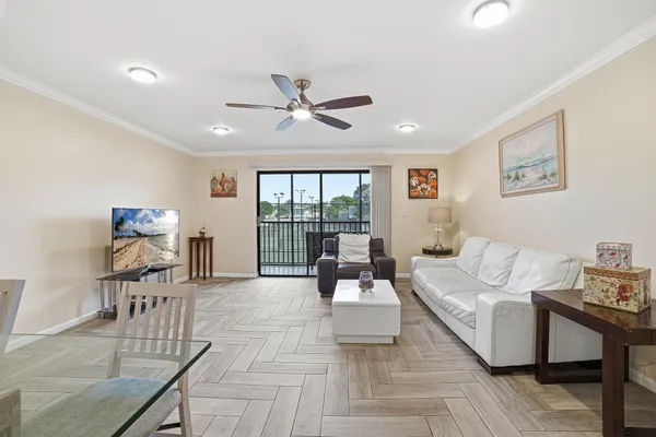 a living room with furniture and a floor to ceiling window