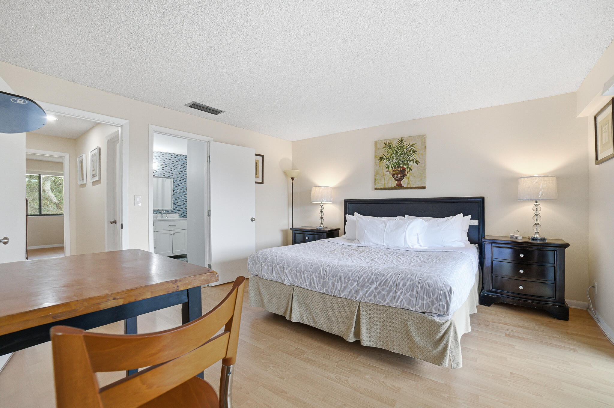 105 Deer Creek Road Deerfield Beach, FL 33442 - Photo 12 of 18 a bedroom with a bed and a table in it