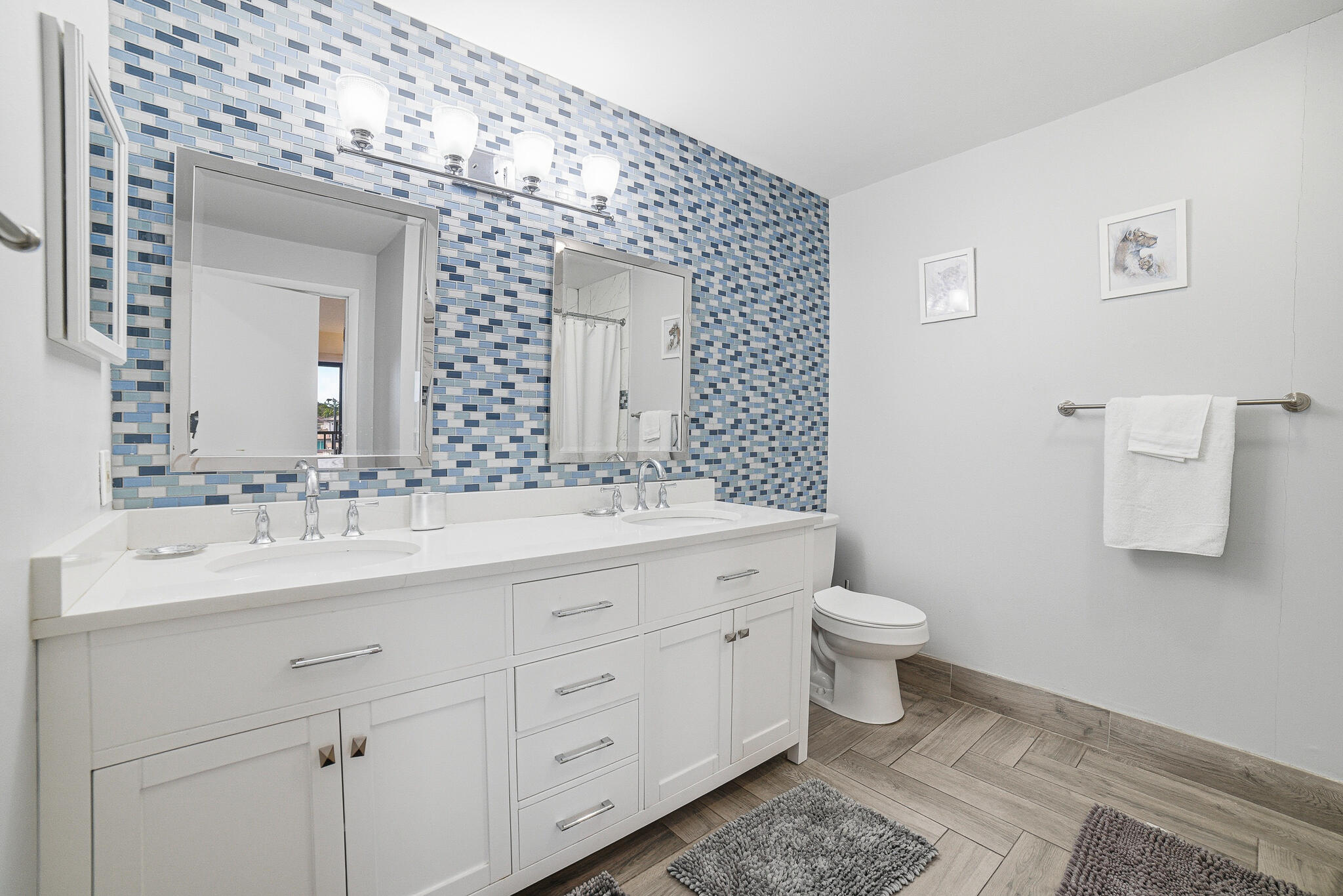 105 Deer Creek Road Deerfield Beach, FL 33442 - Photo 13 of 18 a bathroom with a toilet sink and mirror
