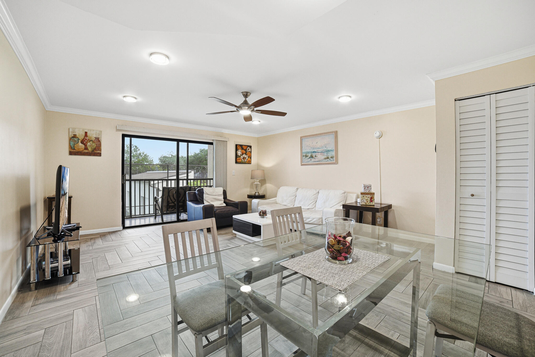 105 Deer Creek Road Deerfield Beach, FL 33442 - Photo 2 of 18 a living room with furniture a flat screen tv and a table