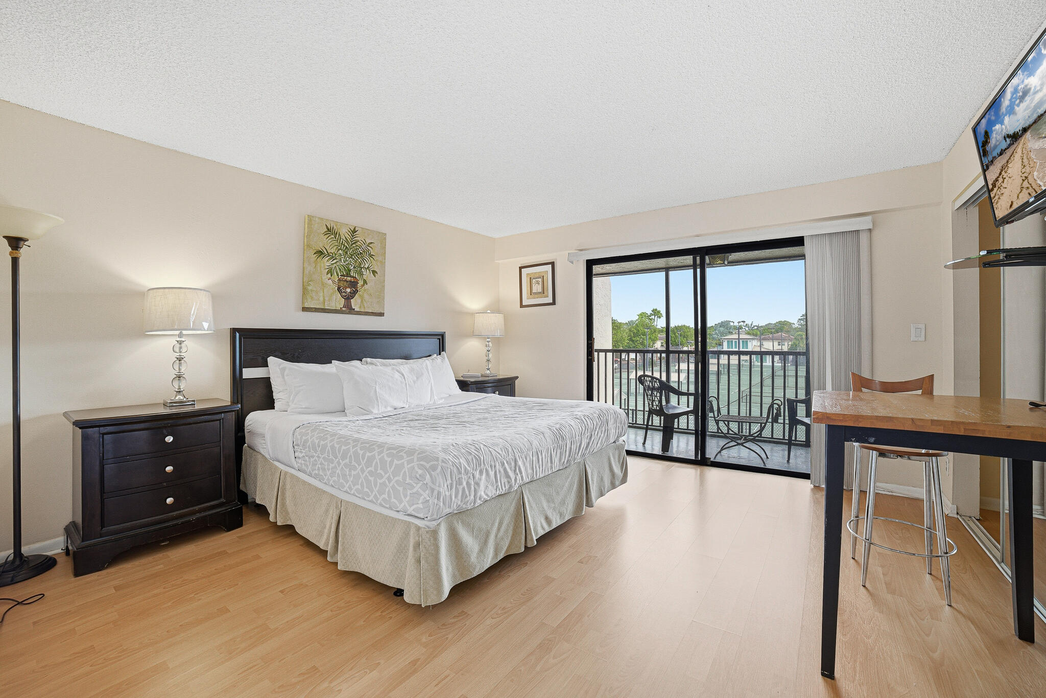 105 Deer Creek Road Deerfield Beach, FL 33442 - Photo 3 of 18 a spacious bedroom with a bed and a large window